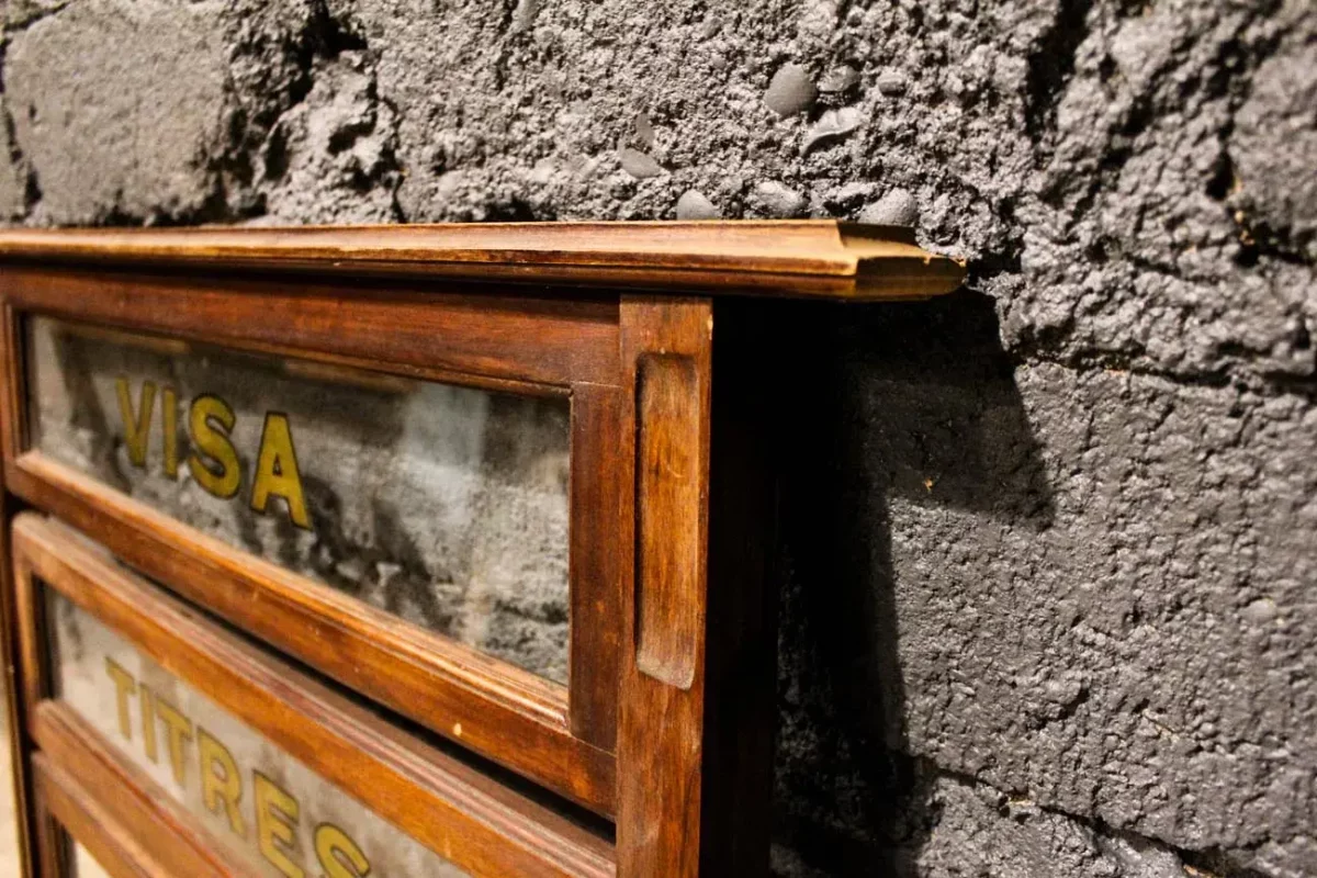 Mobilier de magasin ancien, présentoir vitré et inscriptions détaillées.