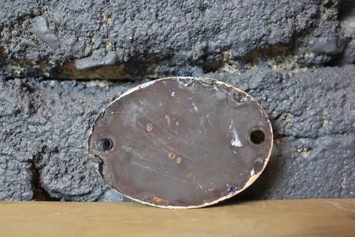Vue d'ensemble de la plaque émaillée WC vintage.